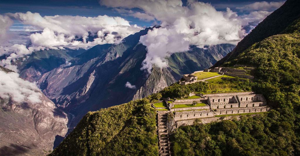 Panoramic view of Choquequirao Incan stone ruins perched high above the deep Apurimac Canyon in Peru.