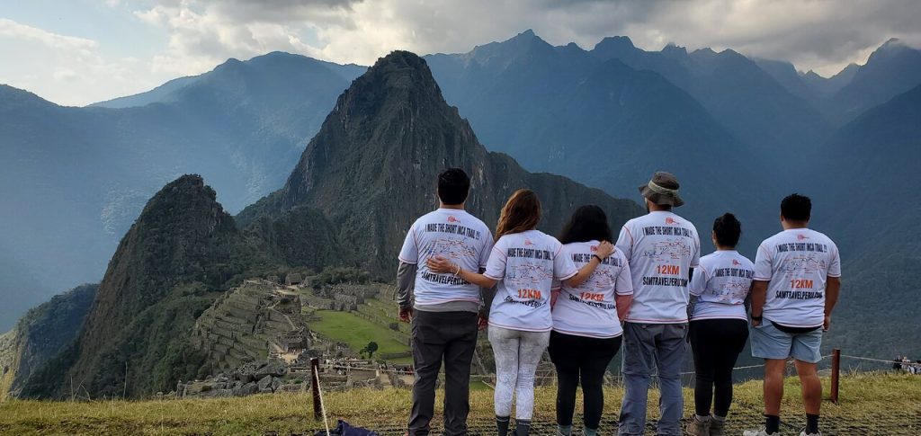 a group of tourists at Inca Machu Picchu with info of TOP 5 INCA TRAIL TOUR OPERATORS 2023