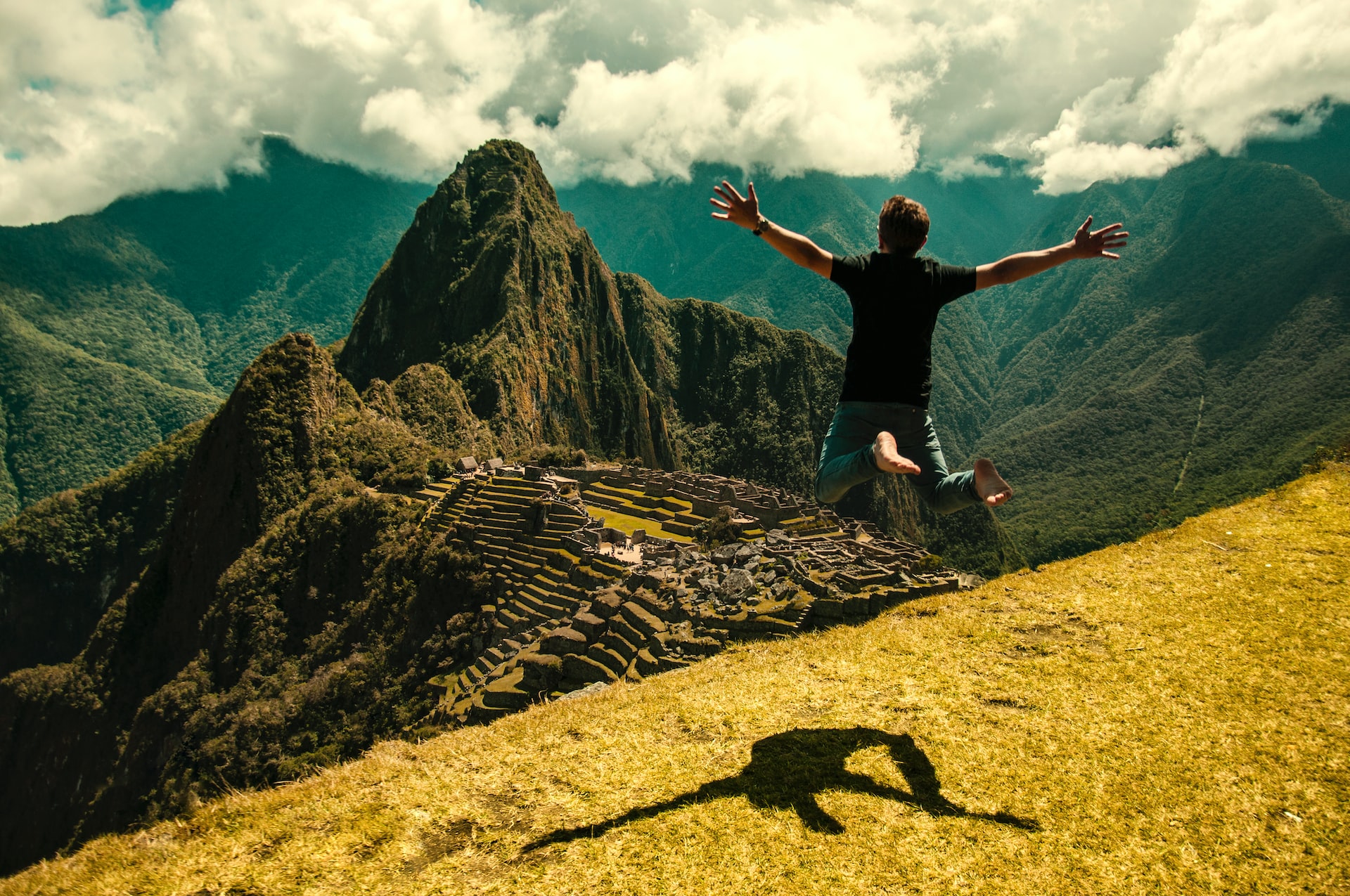 a male traveler jumping at The Ultimate Machu Picchu Trek