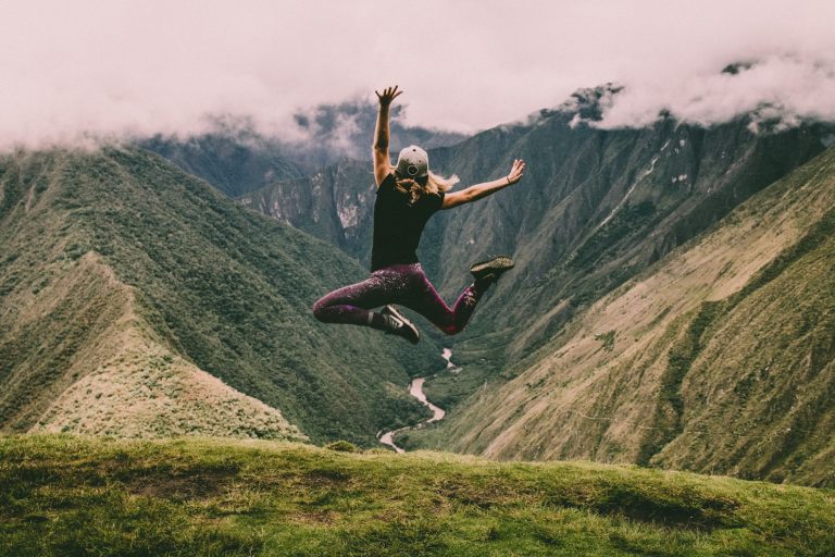 a tourist jumping with excitement on a short Inca trail