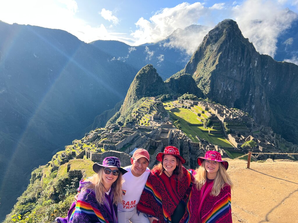 a group of smiling tourists at Machu Picchu Inca Trail VS Lares Trek Information