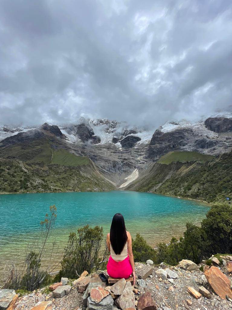 woman is sitting near humantay lake salkantay trek