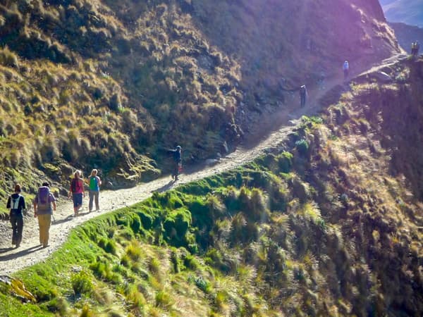 backpackers on a rocky trail to the Salkantay Mountain.