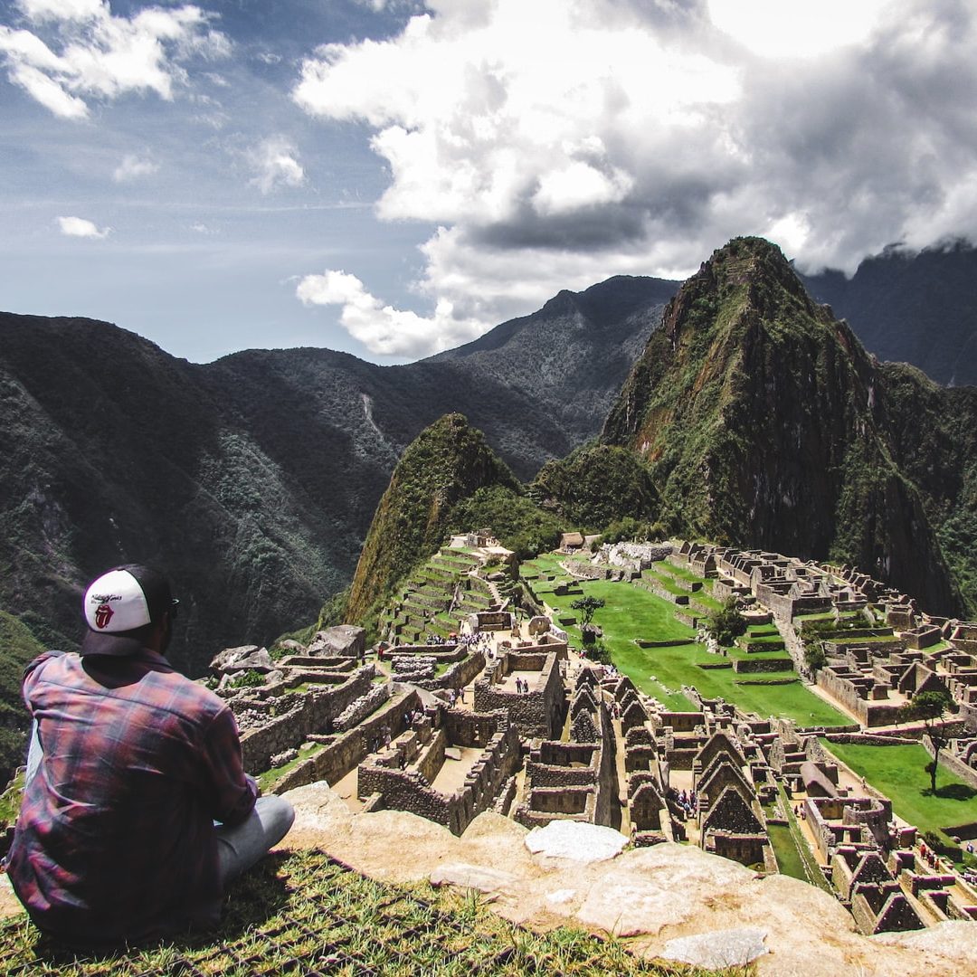 Classic postcard view of Machu Picchu citadel terraces with Huayna Picchu mountain rising in the background.